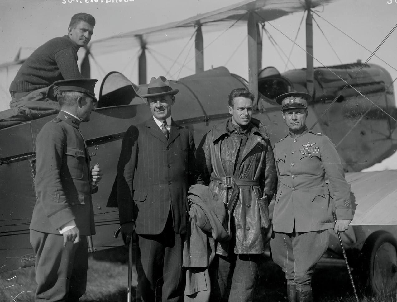 Aviators who participated in 1919 transcontinental reliability and endurance test between Mineola and San Francisco; left to right: SergeantE.N. Bruce, sitting on top of airplane; Colonel Archie Miller; Benedict Crowell, U.S. Assistant Secretary of War; Lieutenant Ross C. Kirkpatrick, Jr.;Brigadier General William “Billy” L. Mitchell (Library of Congress)